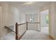 Upstairs hallway featuring carpet and wood banister at 4500 Hollirose Pl, Raleigh, NC 27616