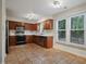 Well-lit kitchen features tile floors, stainless appliances, and wood cabinetry at 4500 Hollirose Pl, Raleigh, NC 27616