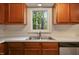Close up of kitchen sink with window view to the exterior at 4500 Hollirose Pl, Raleigh, NC 27616