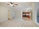 Open-concept living room flows into a kitchen with stainless steel appliances and tile flooring at 4500 Hollirose Pl, Raleigh, NC 27616
