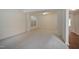 Bright living room with neutral carpet, large windows, and abundant natural light at 4500 Hollirose Pl, Raleigh, NC 27616
