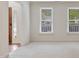Bright and airy living room showcasing carpet and large windows with natural lighting at 4500 Hollirose Pl, Raleigh, NC 27616