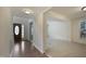 Open living area features wood floors, carpet flooring, and a decorative front door at 4500 Hollirose Pl, Raleigh, NC 27616