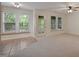 Sunroom with tile and carpet flooring, ceiling fan, and natural lighting from the windows and glass door at 4500 Hollirose Pl, Raleigh, NC 27616