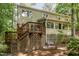 Exterior view of a home with a wooden deck and backyard surrounded by lush trees at 53 Westridge Dr, Durham, NC 27713
