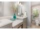 Bathroom with double vanity, light gray cabinets, and a walk-in shower at 53 Westridge Dr, Durham, NC 27713
