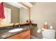Bathroom featuring granite countertops, a single vanity, wood cabinets and neutral-colored walls at 53 Westridge Dr, Durham, NC 27713