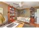 Bedroom featuring wood floors, a ceiling fan, a desk, shelves, and large windows for natural light at 53 Westridge Dr, Durham, NC 27713