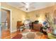 Bedroom with a ceiling fan, light-colored walls, wood floors, a window, and a multi-colored area rug at 53 Westridge Dr, Durham, NC 27713