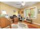 Bedroom with a ceiling fan, light-colored walls, a window, wood floors, and a multi-colored area rug at 53 Westridge Dr, Durham, NC 27713