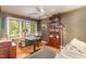 Bedroom featuring wood floors, a ceiling fan, a desk, shelves, and large windows for natural light at 53 Westridge Dr, Durham, NC 27713