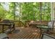 Outdoor deck area featuring a grill, bench seating, and a dining table, perfect for outdoor entertaining at 53 Westridge Dr, Durham, NC 27713