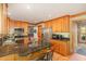 Kitchen with stainless steel appliances, dark granite countertops, and light-colored wood cabinets at 53 Westridge Dr, Durham, NC 27713