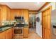 Kitchen featuring stainless steel appliances, wood cabinetry, and a view into another room at 53 Westridge Dr, Durham, NC 27713