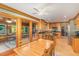 Open kitchen and dining area with wooden cabinetry, granite countertops, and a sunny screened-in porch at 53 Westridge Dr, Durham, NC 27713