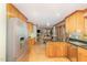 Spacious kitchen with granite countertops, stainless appliances, and wood cabinetry, with a view to dining area at 53 Westridge Dr, Durham, NC 27713
