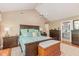 Main bedroom with a large bed, dark furniture, and an attached bathroom at 53 Westridge Dr, Durham, NC 27713