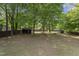 Large backyard featuring mature trees, two storage sheds, and plenty of green space at 5713 Timber Ridge Dr, Raleigh, NC 27609