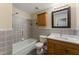 Bathroom featuring ceramic tiles and a shower/tub with sliding shower head at 5713 Timber Ridge Dr, Raleigh, NC 27609