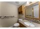 Bathroom features a decorative backsplash, a wooden cabinet, and a large mirror at 5713 Timber Ridge Dr, Raleigh, NC 27609
