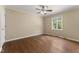 Cozy bedroom with hardwood floors, a ceiling fan, and natural light from the window at 5713 Timber Ridge Dr, Raleigh, NC 27609