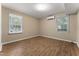 Bright bedroom features hardwood floors, large windows, and mini split system at 5713 Timber Ridge Dr, Raleigh, NC 27609