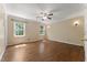 Bedroom featuring two windows, hardwood flooring, neutral walls, and ceiling fan at 5713 Timber Ridge Dr, Raleigh, NC 27609