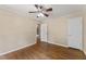 A spacious bedroom with wood floors, ceiling fan, and an attached bathroom at 5713 Timber Ridge Dr, Raleigh, NC 27609