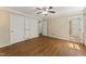 Bedroom featuring hardwood floors, a ceiling fan, and a closet at 5713 Timber Ridge Dr, Raleigh, NC 27609