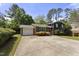 Exterior view of home with a garage, brick facade, lush plants and long driveway at 5713 Timber Ridge Dr, Raleigh, NC 27609