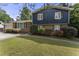Exterior shot of a two-story home featuring brick and siding, manicured landscaping, and a well-maintained lawn at 5713 Timber Ridge Dr, Raleigh, NC 27609
