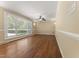 Bright living room with hardwood floors and large windows overlooking the landscape at 5713 Timber Ridge Dr, Raleigh, NC 27609
