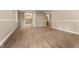 This living room offers vinyl floors, wainscoting and French doors leading to the foyer at 5713 Timber Ridge Dr, Raleigh, NC 27609