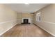 Bright living room featuring a fireplace, wainscoting, and vinyl flooring at 5713 Timber Ridge Dr, Raleigh, NC 27609