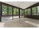 Bright sunroom features large windows, skylights, and access to the deck at 5713 Timber Ridge Dr, Raleigh, NC 27609