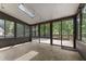 Bright sunroom with multiple windows provides views of backyard and deck at 5713 Timber Ridge Dr, Raleigh, NC 27609
