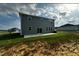 Back view of house with large patio and lush yard at 580 Thomas Gage Dr, Fuquay Varina, NC 27526