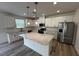 Modern kitchen with stainless steel appliances, granite countertops, and a large kitchen island at 580 Thomas Gage Dr, Fuquay Varina, NC 27526