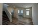 Inviting living room featuring hardwood floors and a bright, open floor plan, with staircase to the side at 580 Thomas Gage Dr, Fuquay Varina, NC 27526