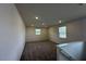 Loft space featuring carpeted floors and two windows at 580 Thomas Gage Dr, Fuquay Varina, NC 27526