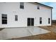 The backyard has a concrete patio and a sliding glass door to enter the house at 60 Rosewood Ln, Youngsville, NC 27596