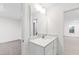 Bathroom vanity featuring a quartz countertop and a sleek mirror with modern lighting at 60 Rosewood Ln, Youngsville, NC 27596
