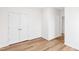 Bright bedroom featuring light hardwood floors, neutral walls, and a double-door closet, perfect for storage at 60 Rosewood Ln, Youngsville, NC 27596