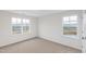 Cozy bedroom with neutral carpet, two windows providing natural light at 60 Rosewood Ln, Youngsville, NC 27596