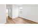 Bright bedroom features wood-look flooring and a window offering natural light at 60 Rosewood Ln, Youngsville, NC 27596