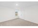 Bright bedroom featuring neutral carpet, a window, and a closet with double doors at 60 Rosewood Ln, Youngsville, NC 27596