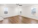 Spacious bedroom boasts ample natural light from multiple windows and wood-look flooring at 60 Rosewood Ln, Youngsville, NC 27596