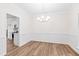 Elegant dining room with chair rail and light hardwood floors, accented by a modern chandelier at 60 Rosewood Ln, Youngsville, NC 27596