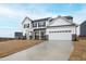 A beautiful two-story white home with black shutters, an attached garage, and a large driveway at 60 Rosewood Ln, Youngsville, NC 27596