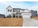 Inviting two-story home with a two-car garage, black shutters and a well-manicured lawn at 60 Rosewood Ln, Youngsville, NC 27596